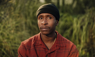 a man in a red shirt and a black hat