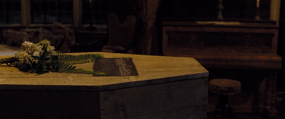 a wooden box with flowers on top of it