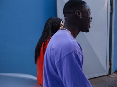 a man and a woman standing in front of a door