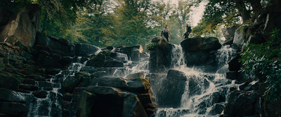 a group of people standing on top of a waterfall