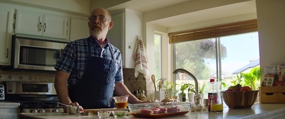 a man standing in a kitchen preparing food