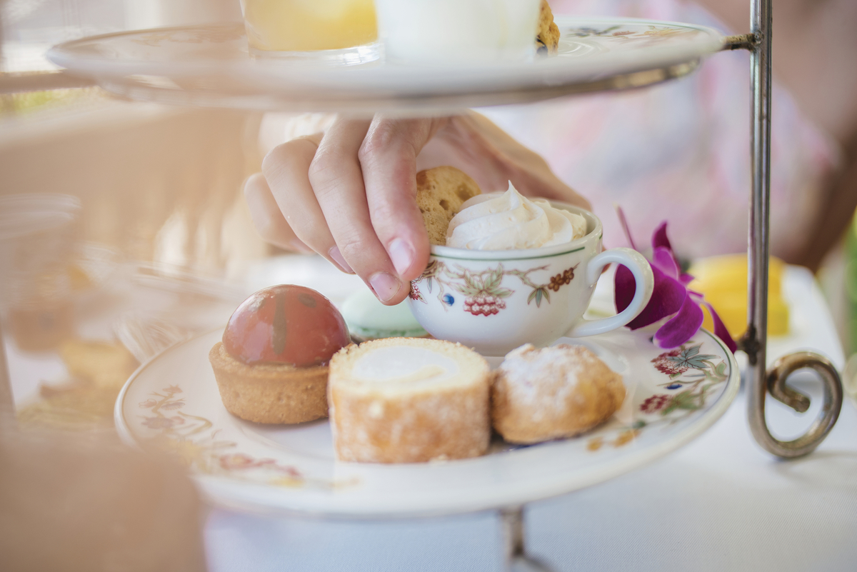 a person putting a cup of tea on a plate