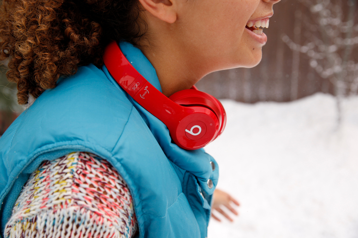 a woman wearing red headphones in the snow