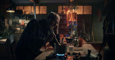 a man sitting at a table in a dark room