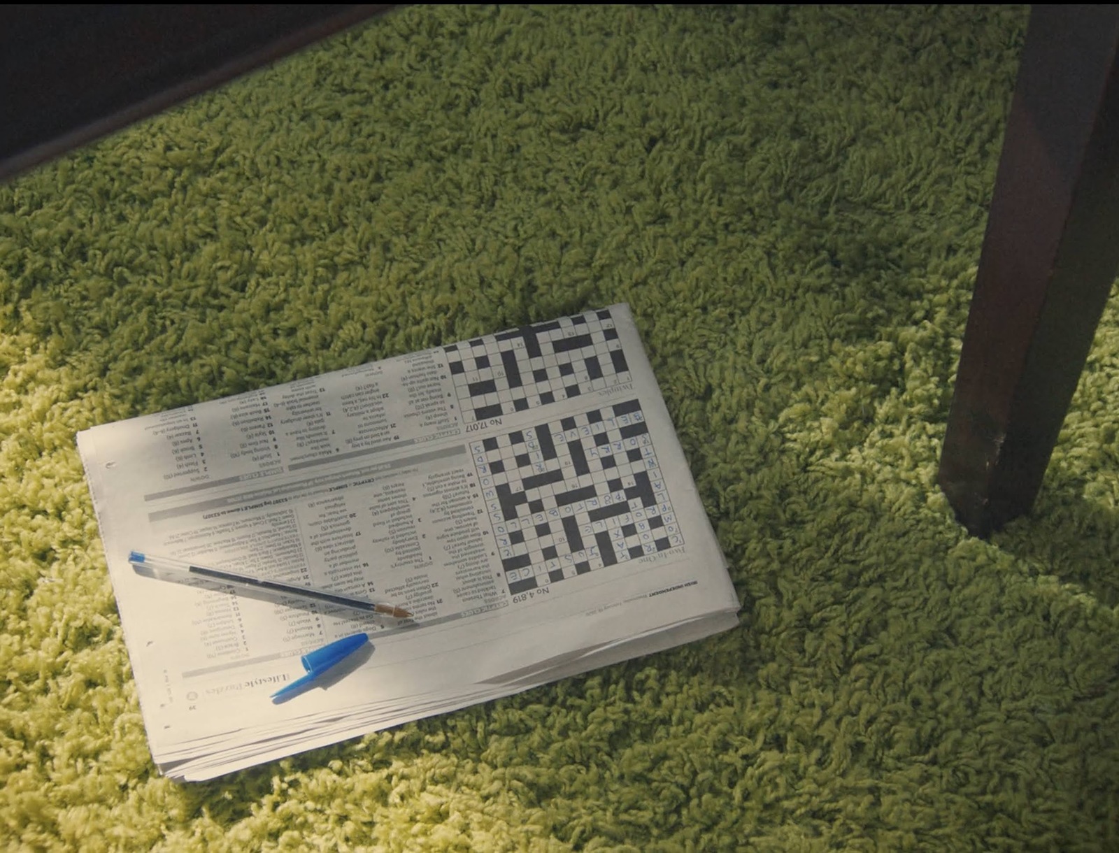 a piece of paper sitting on top of a green rug