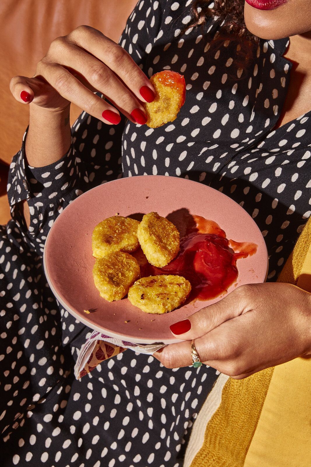 a woman is holding a plate of food