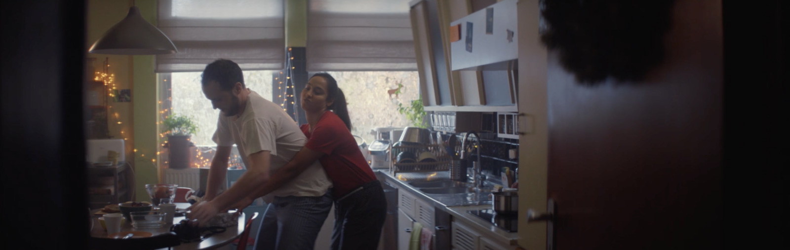 a man and a woman standing in a kitchen