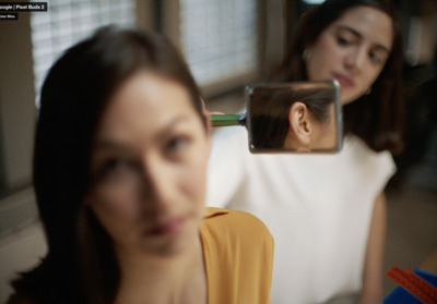 a woman looking at her reflection in a mirror