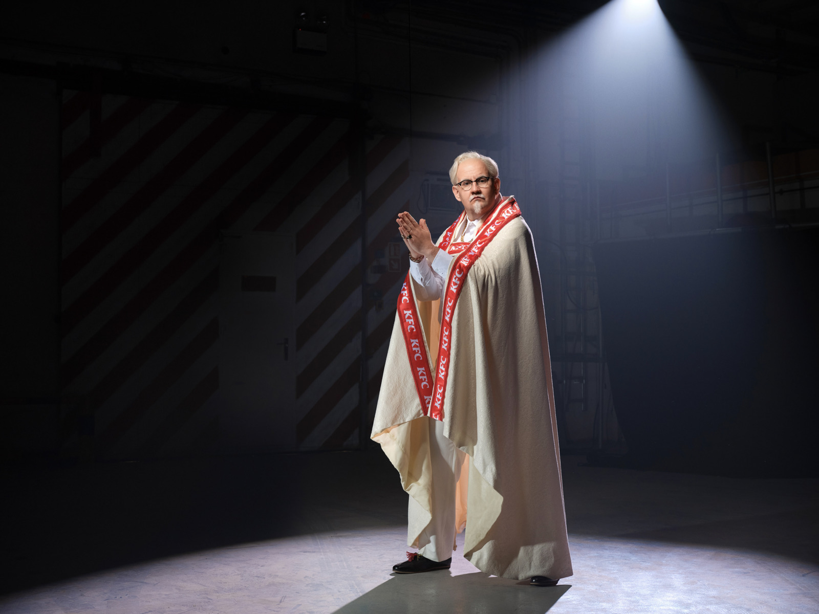 a man standing on a stage wearing a robe