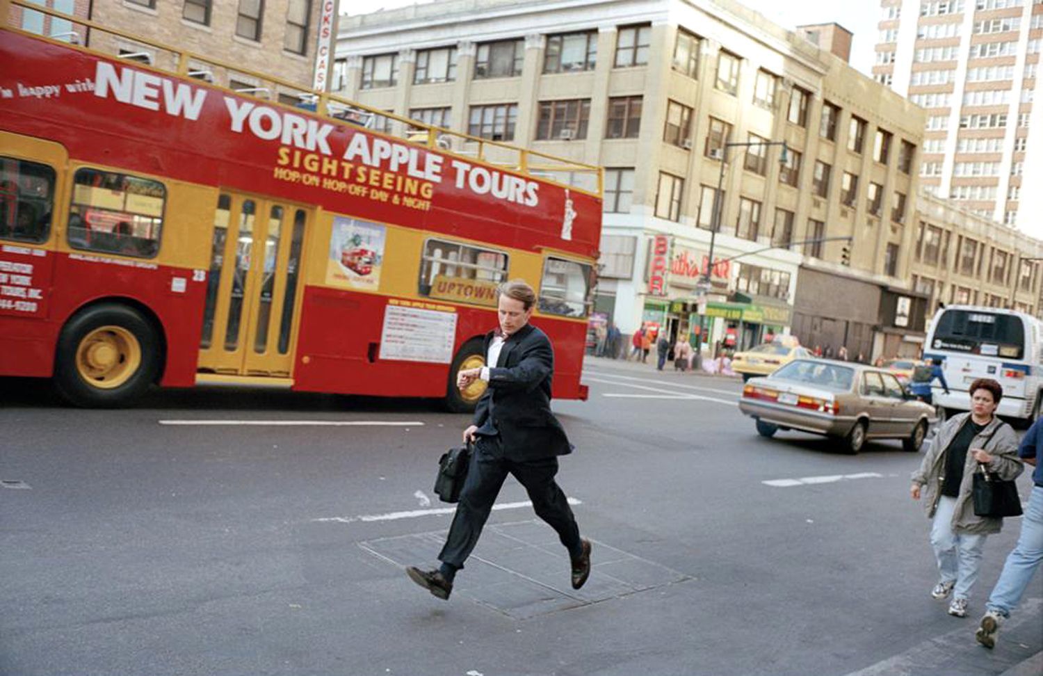 a man in a suit is crossing the street