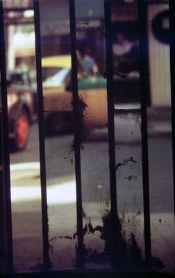 a view of a street from behind a fence