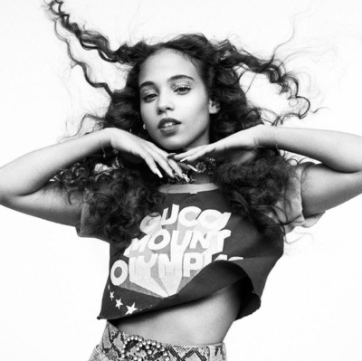 a black and white photo of a woman with curly hair