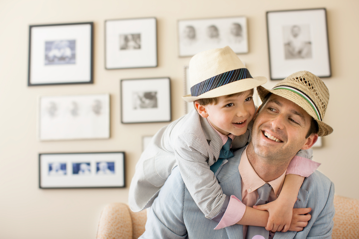 a man holding a little boy in his arms