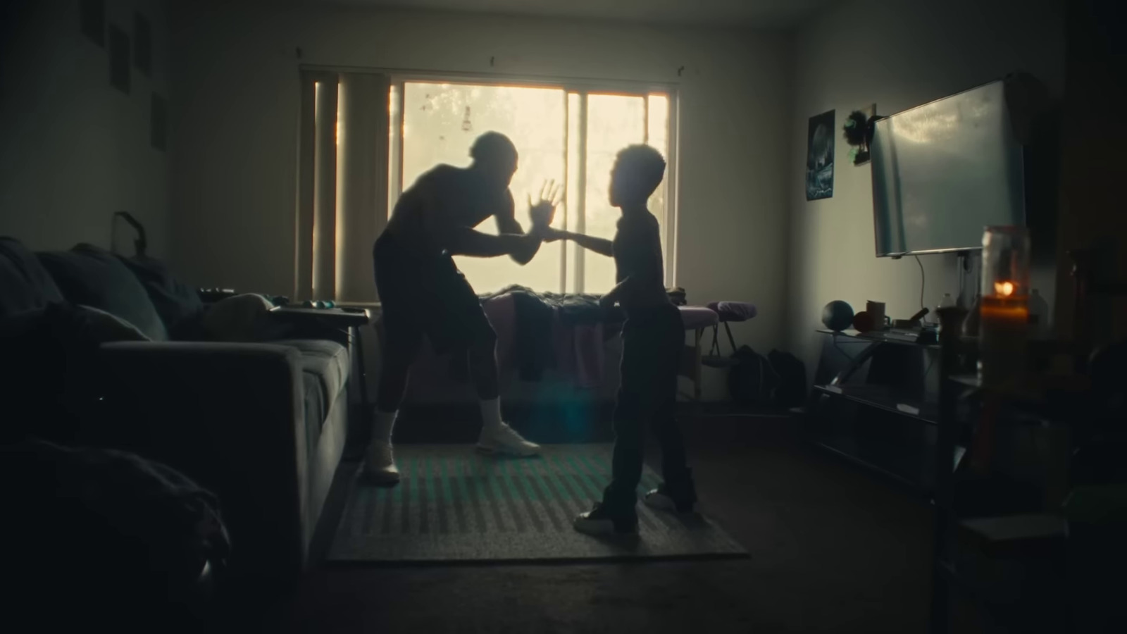 a couple of people standing in a living room