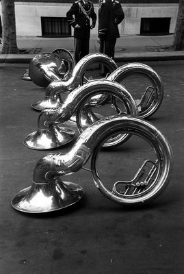 a black and white photo of a group of brass instruments