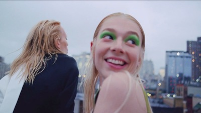 a woman with green eyes standing next to another woman