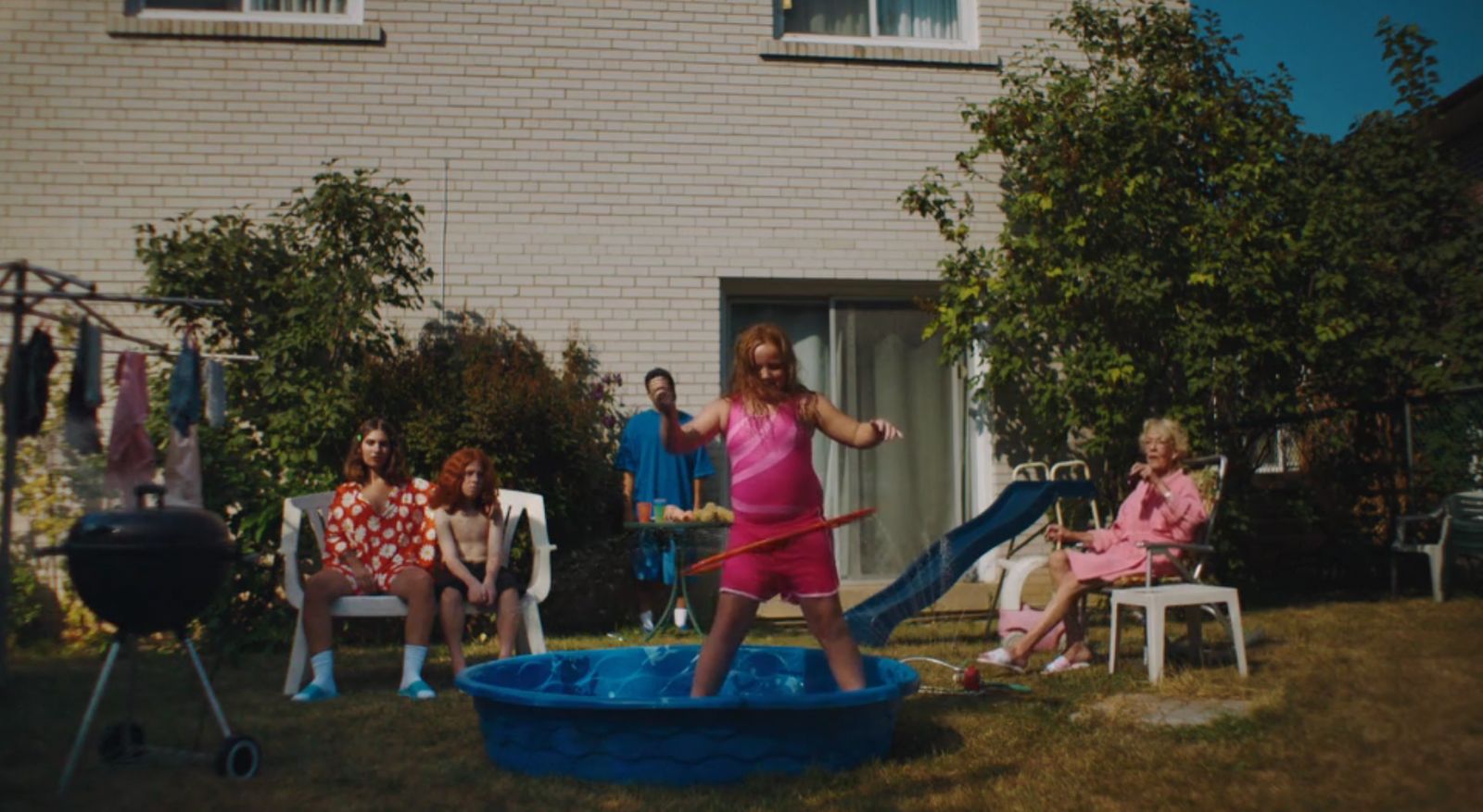 a woman in a pink dress is playing in a blue pool