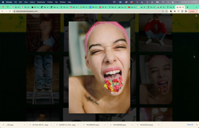 a woman with pink hair eating a candy bar