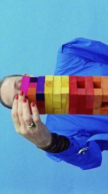 a woman holding a colorful object in her hands