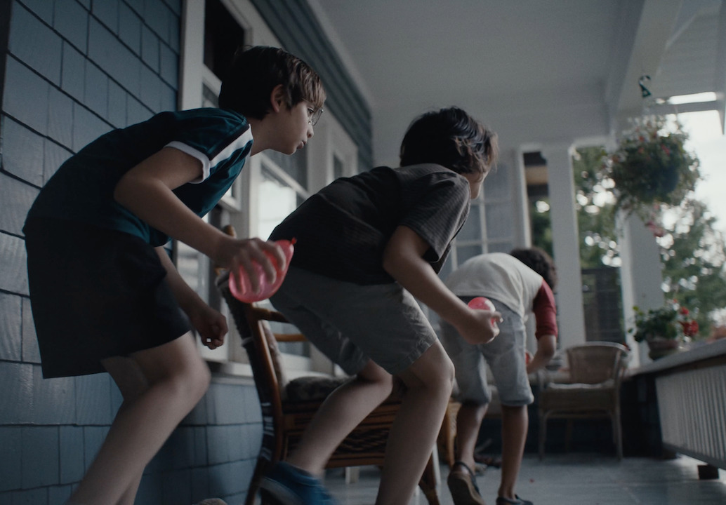 a group of young boys playing a game of ping pong