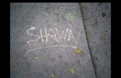 a sidewalk with the word sham written on it