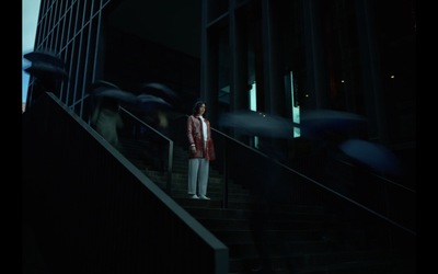 a woman standing on a set of stairs in the dark