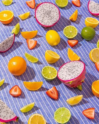 a table topped with sliced fruit on top of a blue table cloth