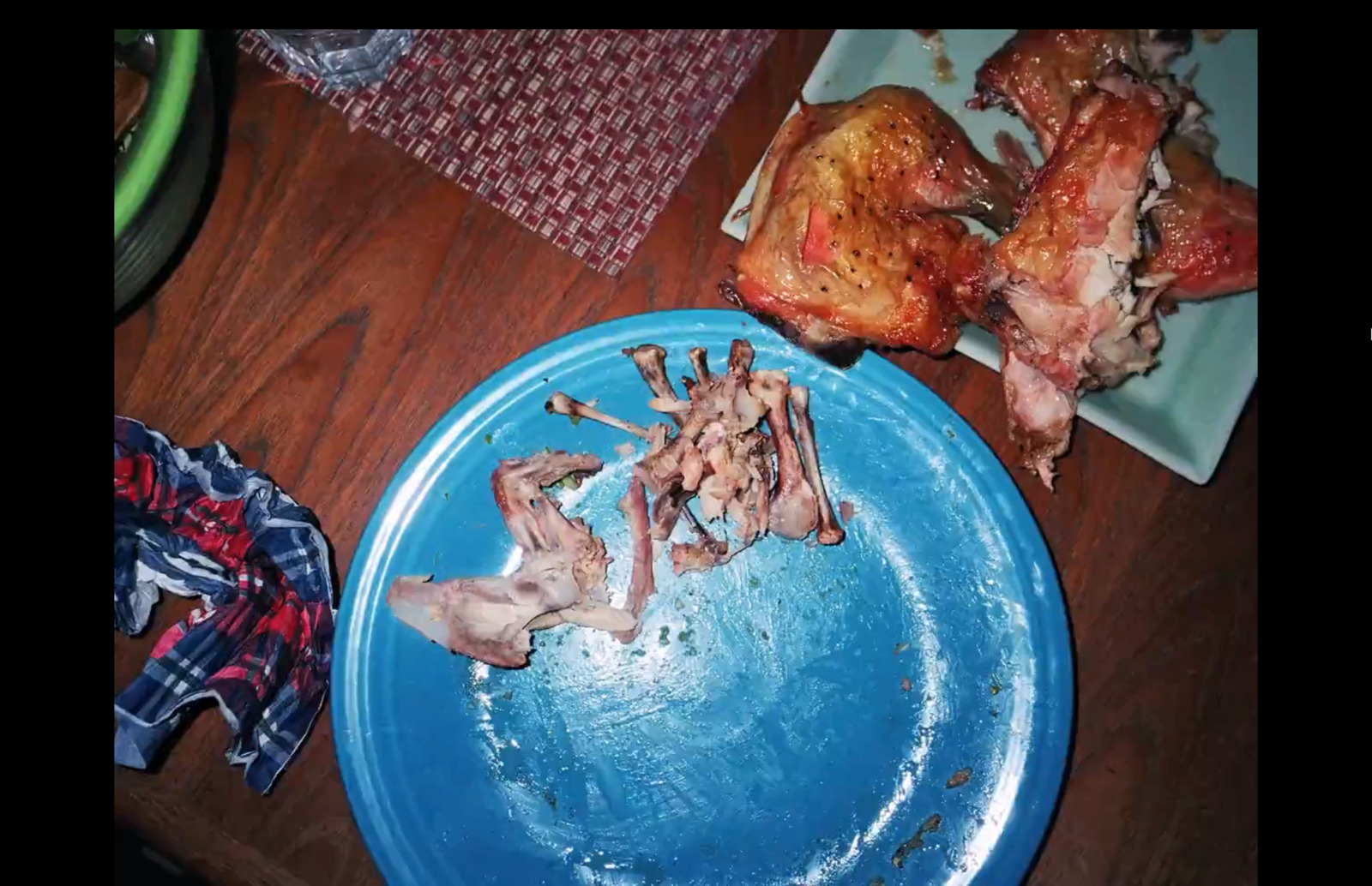 a blue plate topped with meat on top of a wooden table