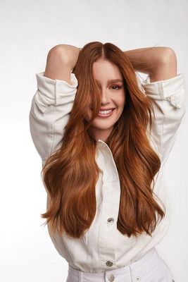 a woman with long red hair posing for a picture