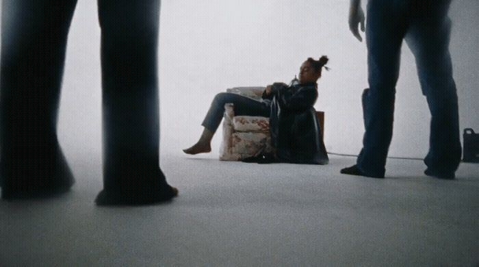 a woman sitting on a chair in front of a group of people