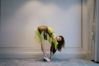 a woman in a dress and high heels posing for a picture