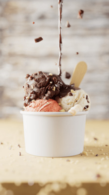 a cup of ice cream with a spoon sticking out of it