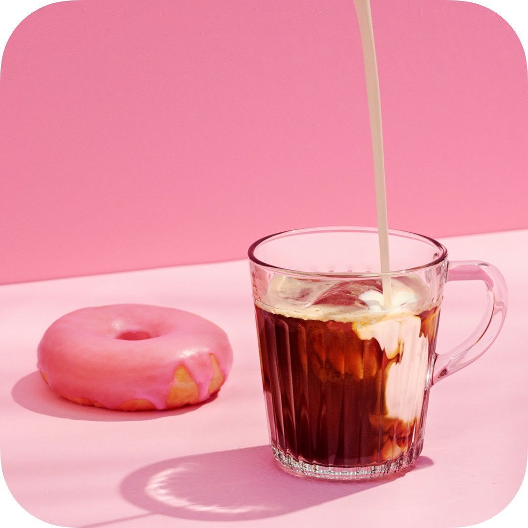 a donut sitting next to a cup of coffee