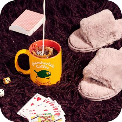 a pair of slippers sitting next to a cup of coffee