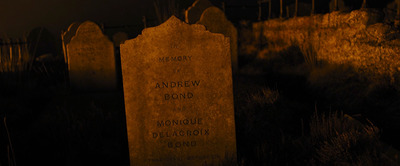 a headstone in a cemetery at night