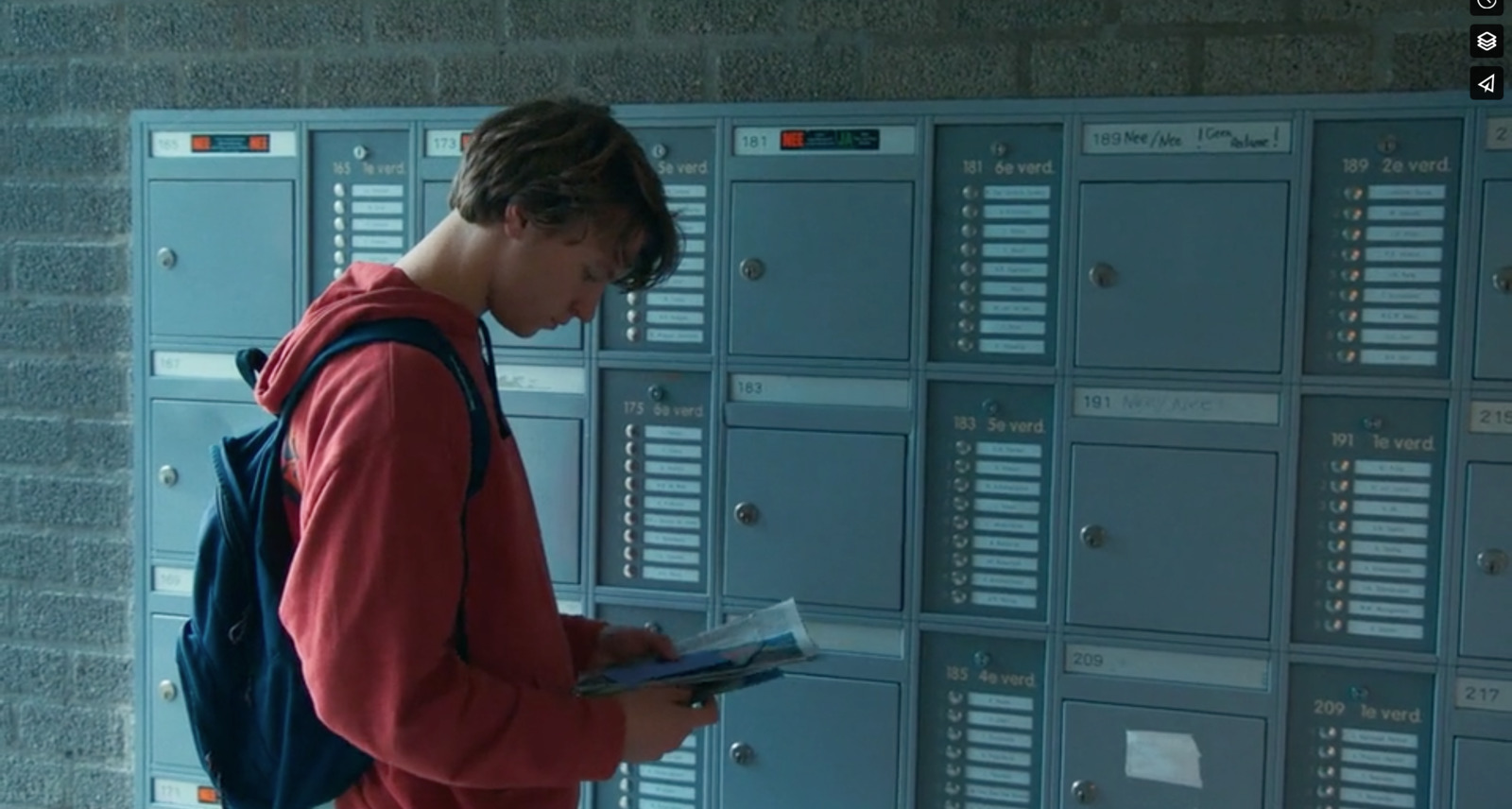 a man standing in front of a bunch of lockers