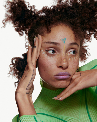 a woman with freckles on her face posing for a picture