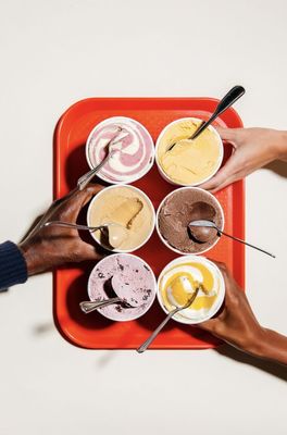 a group of people eating ice cream on top of a red tray