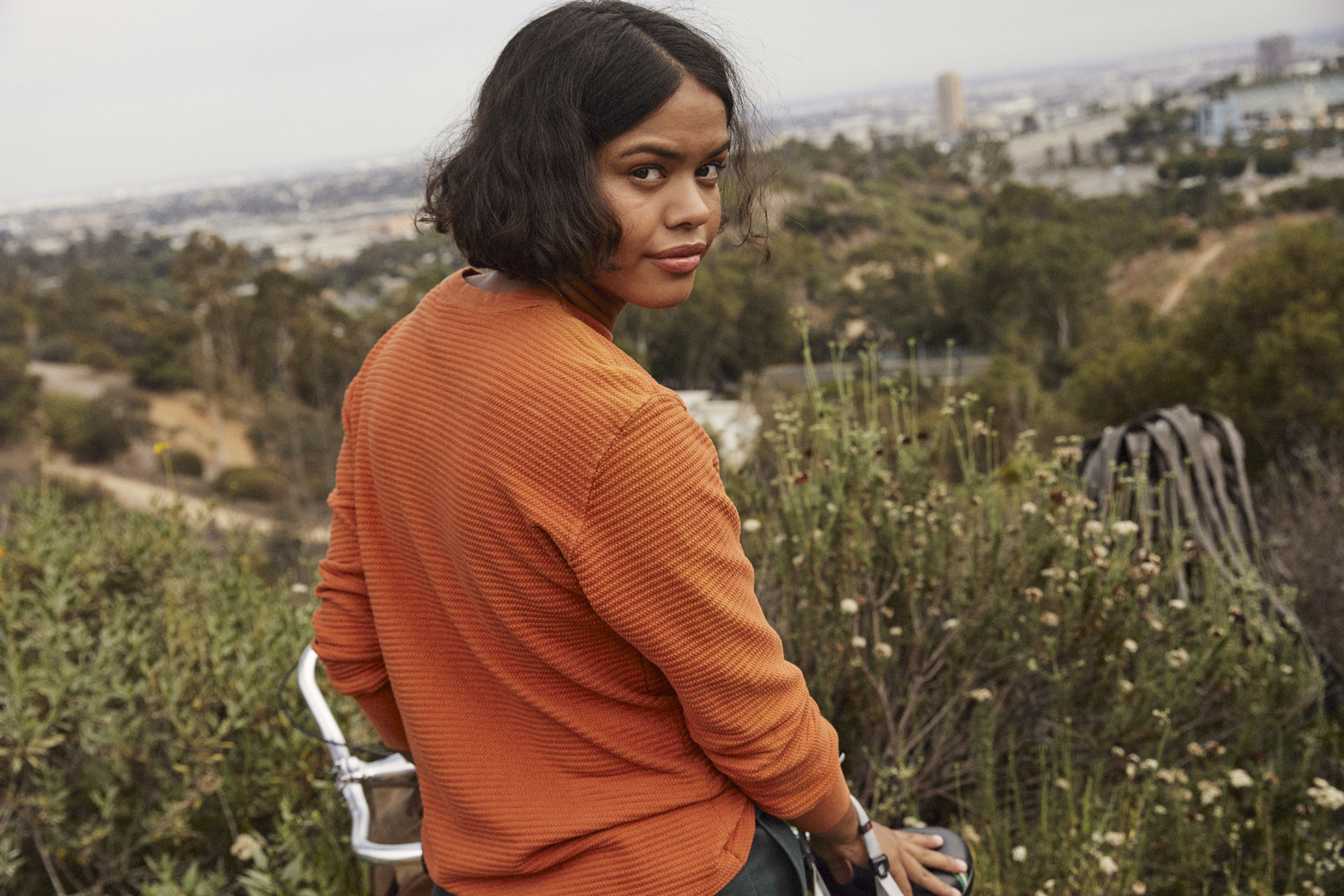 a woman sitting on a chair looking at the camera