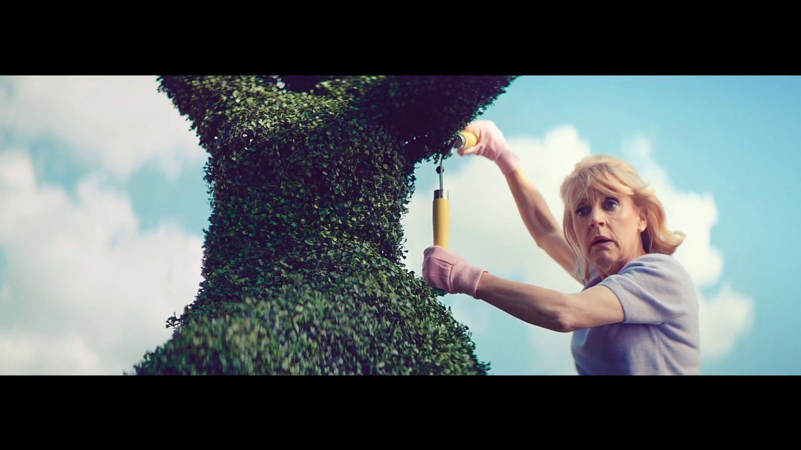 a woman holding a tennis racquet on top of a tree