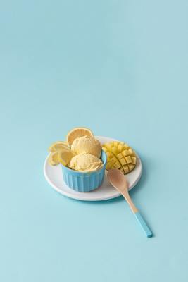 a bowl of ice cream next to a plate of fruit