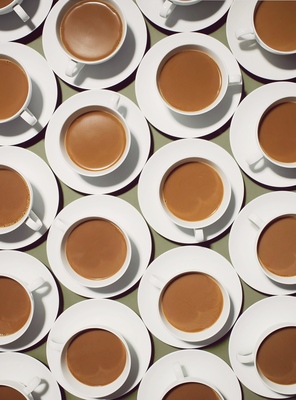 a table topped with lots of cups of coffee