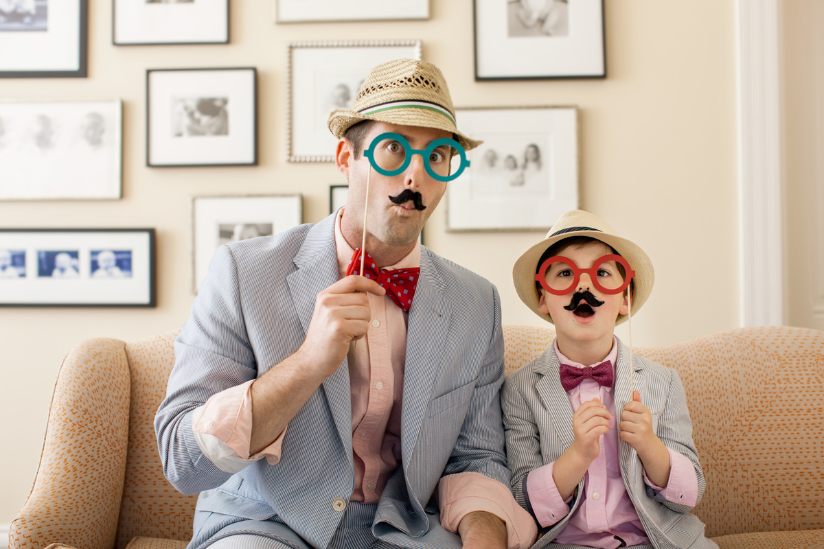 a man and a child wearing fake mustaches