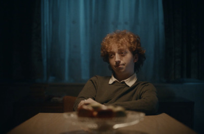 a man sitting at a table in a dark room