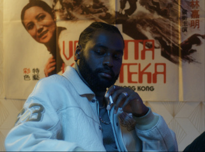 a man in a white jacket looking at his cell phone