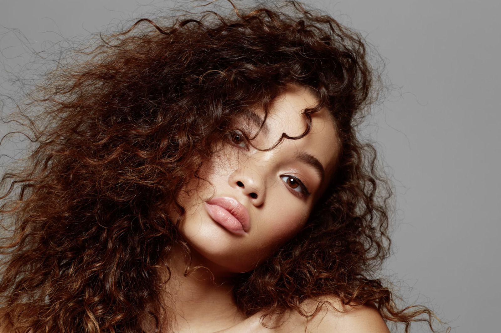 a close up of a woman with curly hair