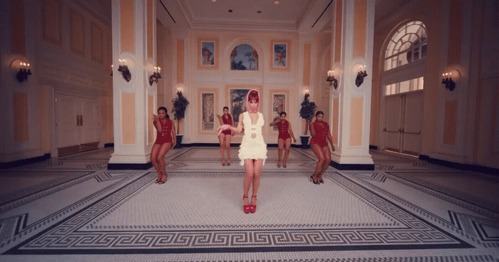 a woman in a white dress standing in a room