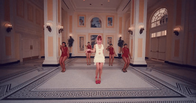 a woman in a white dress standing in a room