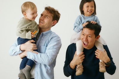 a man holding a baby and two other people