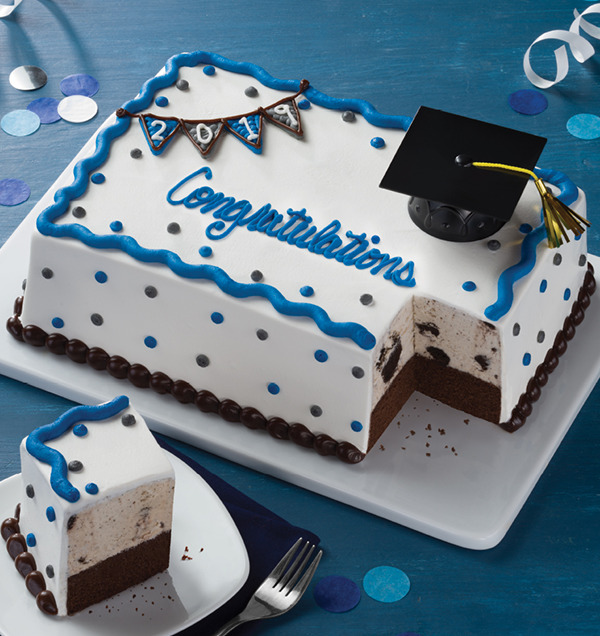 a graduation cake with a piece missing from it